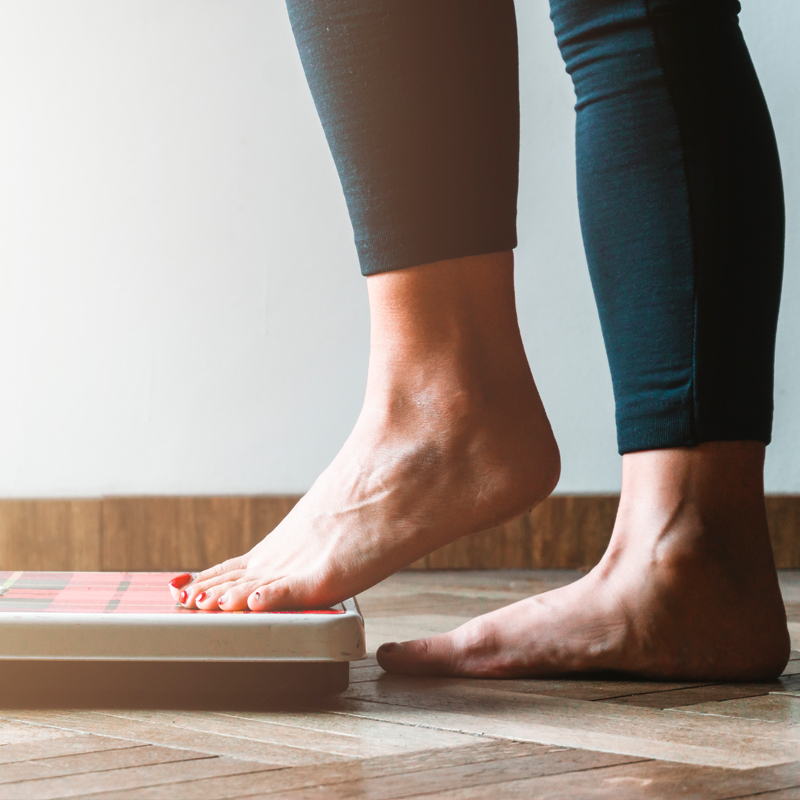 woman stepping on scale