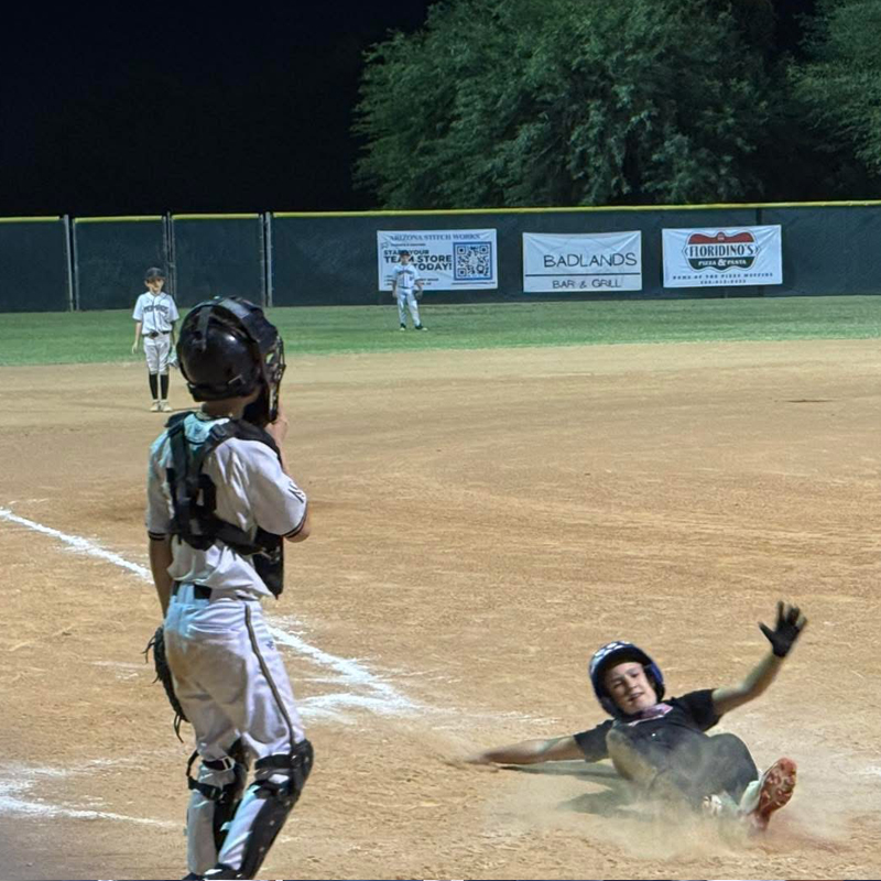 girls baseball sliding into home